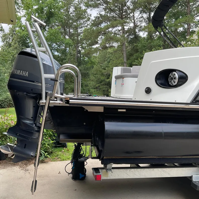 Slide: The Image of 2019 Sylvan SE-CRS25 pontoon boat with Yamaha outboard motor, parked outdoors. - 6