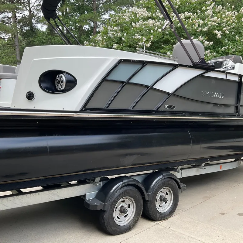 Slide: The Image of 2019 Sylvan SE-CRS25 pontoon boat on trailer, side view with sleek design. - 7