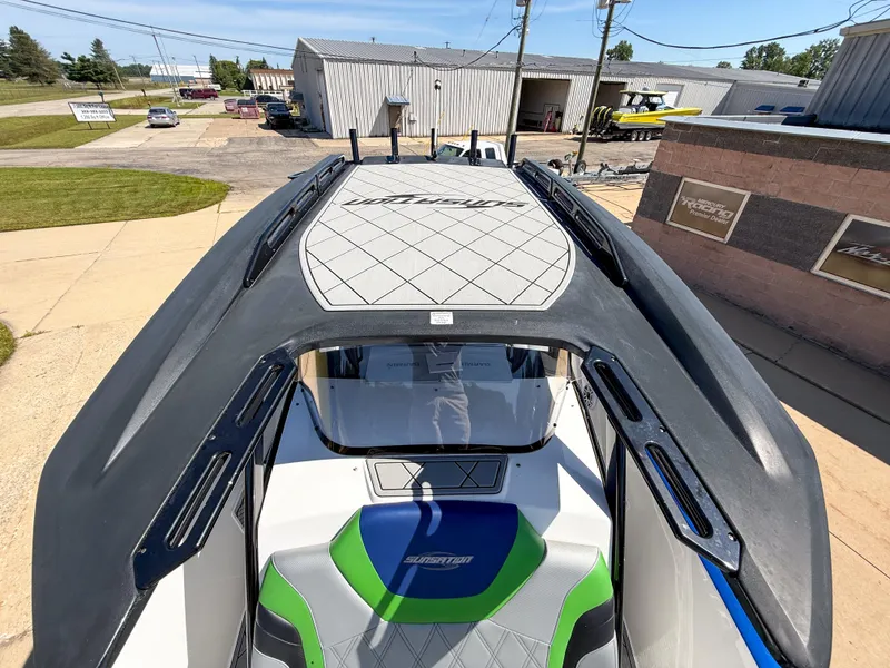 Slide: The Image of 2018 Sunsation 32 CCX boat, top view, parked outdoors near industrial buildings. - 14