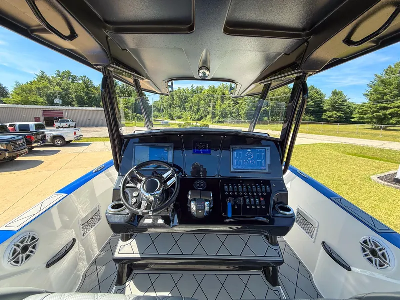 Slide: The Image of 2018 Sunsation 32 CCX boat cockpit with modern controls and steering wheel. - 4