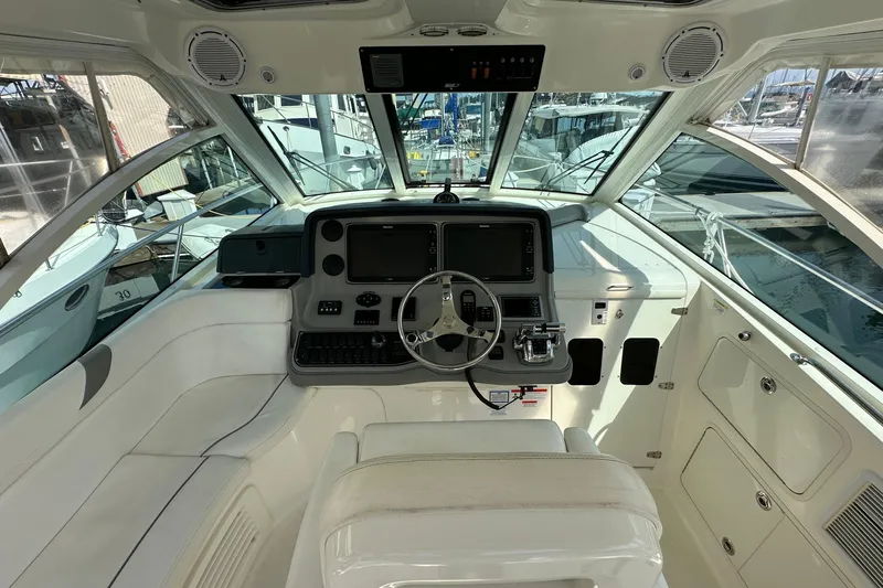 Slide: The Image of 2013 Boston Whaler 345 Conquest helm with modern navigation equipment and panoramic windows. - 11