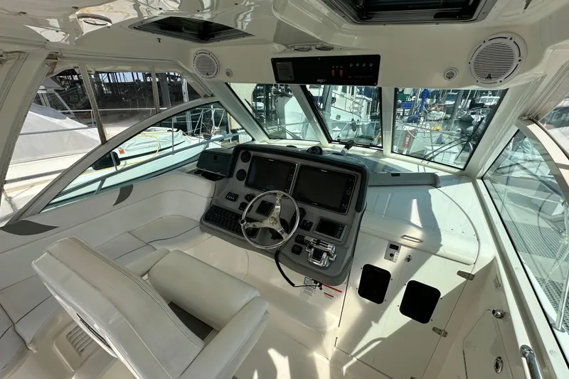Slide: The Image of Interior of 2013 Boston Whaler 345 Conquest boat, featuring helm and navigation equipment. - 13