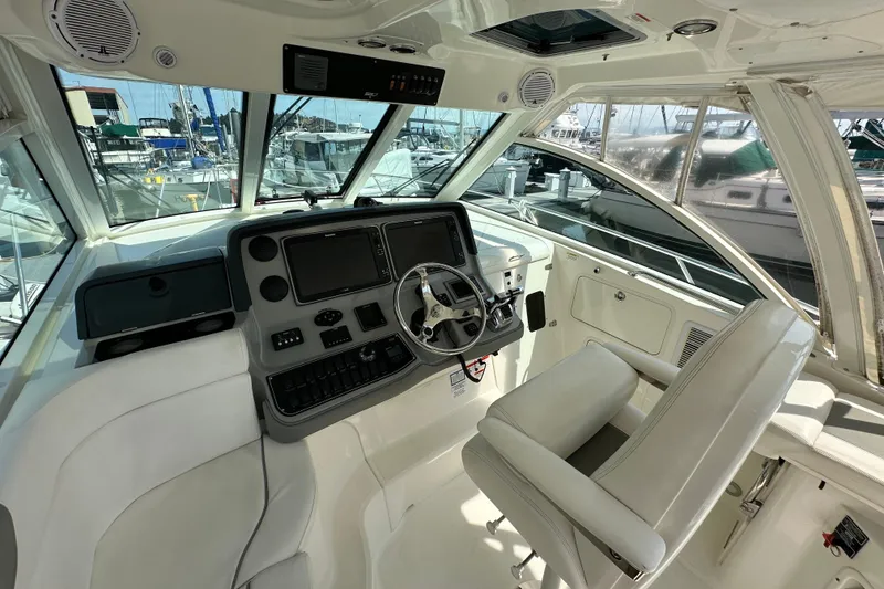 Slide: The Image of 2013 Boston Whaler 345 Conquest helm with modern controls and comfortable seating. - 14