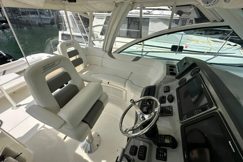 Slide: The Image of 2013 Boston Whaler 345 Conquest helm with modern controls and comfortable seating. - 15