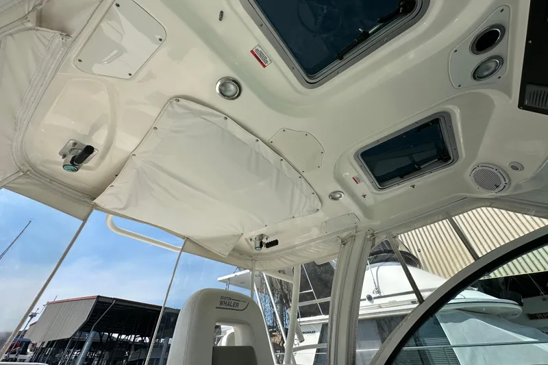 Slide: The Image of Interior view of 2013 Boston Whaler 345 Conquest boat, showcasing ceiling and seating details. - 18