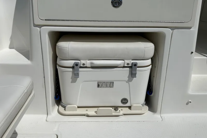 Slide: The Image of 2013 Boston Whaler 345 Conquest cooler storage with cushioned seat. - 22