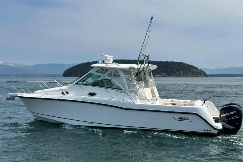 Slide: The Image of 2013 Boston Whaler 345 Conquest boat cruising on open water. - 5