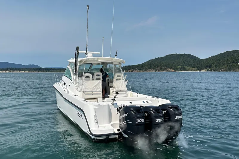 Slide: The Image of 2013 Boston Whaler 345 Conquest boat with triple Mercury engines on open water. - 8