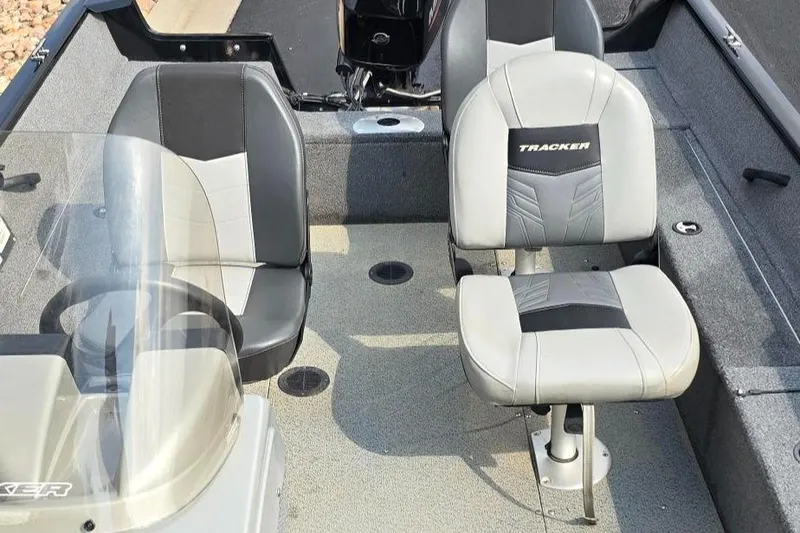 Slide: The Image of 2019 Tracker PGV16 boat interior with two cushioned seats and steering console. - 3