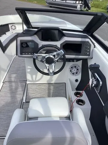 Slide: The Image of 2026 Cobalt CS23 boat cockpit with modern steering and control panel. - 14