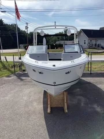 Slide: The Image of 2026 Cobalt CS23 boat displayed outdoors on a wooden stand. - 3