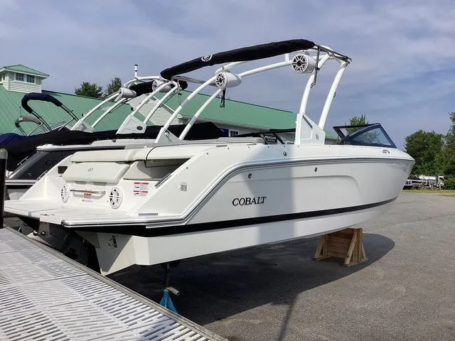 Slide: The Image of 2026 Cobalt CS23 boat with sleek design, docked outdoors under a clear sky. - 4