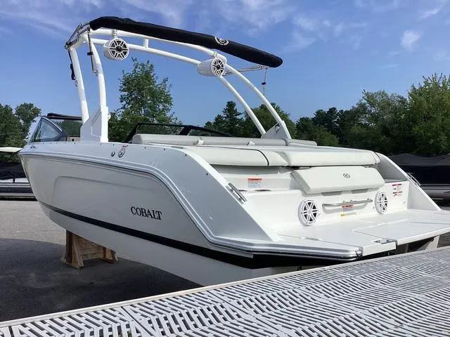 Slide: The Image of 2026 Cobalt CS23 boat with sleek design, docked outdoors under clear sky. - 5