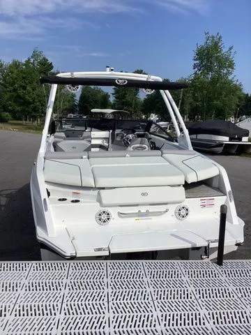 Slide: The Image of 2026 Cobalt CS23 boat, white exterior, docked, with seating and speakers visible. - 7