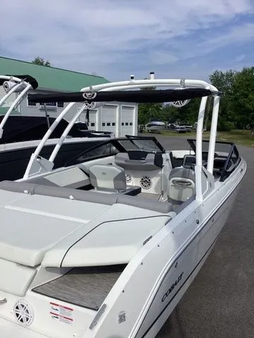 Slide: The Image of 2026 Cobalt CS23 boat with sleek design, white exterior, and spacious seating. - 9