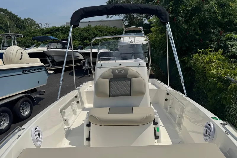 Slide: The Image of 2026 Key West 1720 CC boat with seating, parked among other boats. - 2