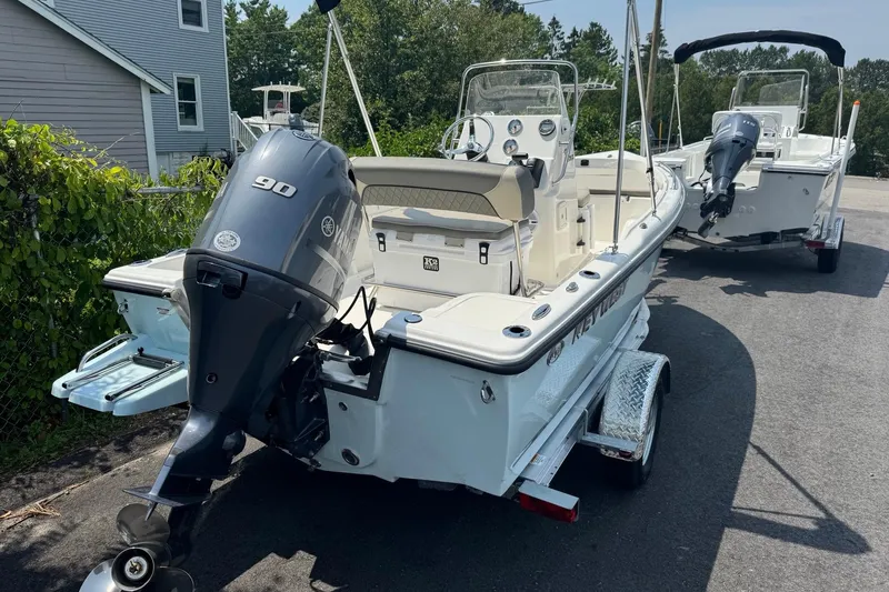 Slide: The Image of 2026 Key West 1720 CC boat with 90 HP engine on trailer, parked outdoors. - 6