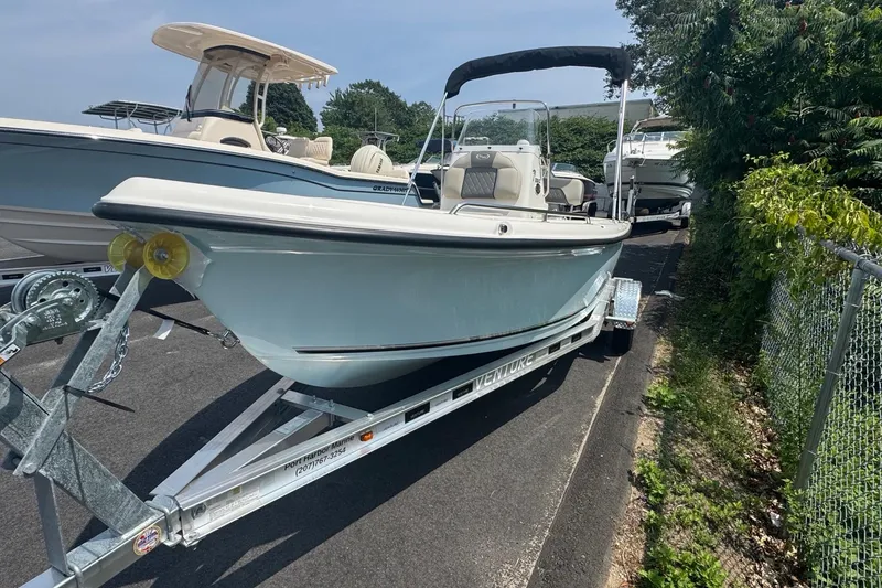 Slide: The Image of 2026 Key West 1720 CC boat on trailer, parked outdoors, sunny day. - 8