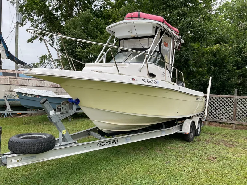 The Image of 2009 Key West 2300WA boat on trailer, parked on grass. - 1
