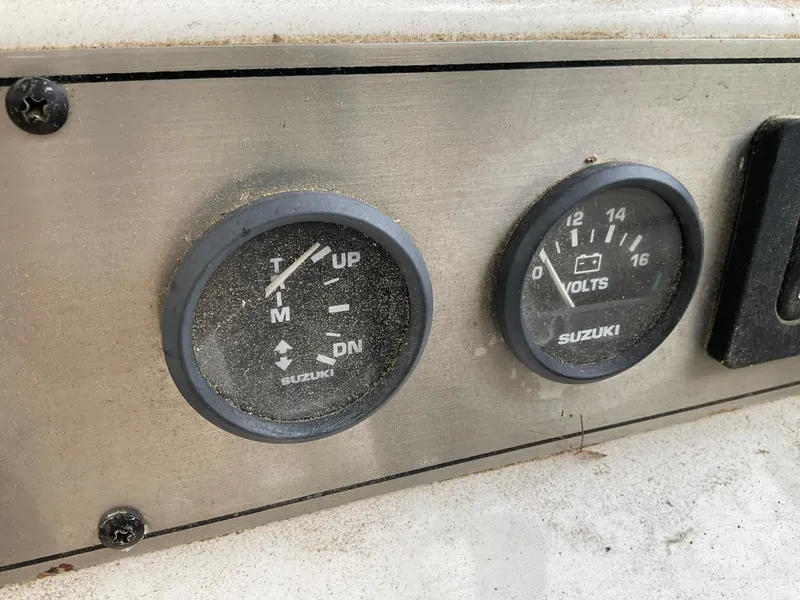 Slide: The Image of Dashboard gauges on a 2009 Key West 2300WA boat, showing trim and voltage levels. - 11