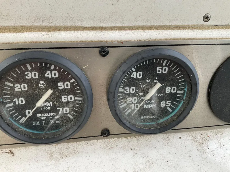 Slide: The Image of Close-up of Suzuki RPM and speedometer gauges on a 2009 Key West 2300WA boat. - 12