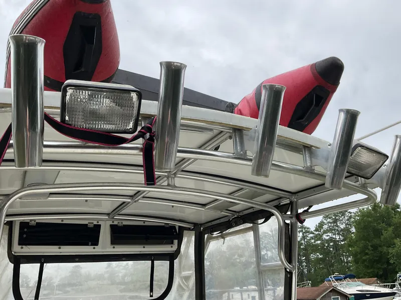 Slide: The Image of 2009 Key West 2300WA boat with rod holders and red kayak on top. - 19