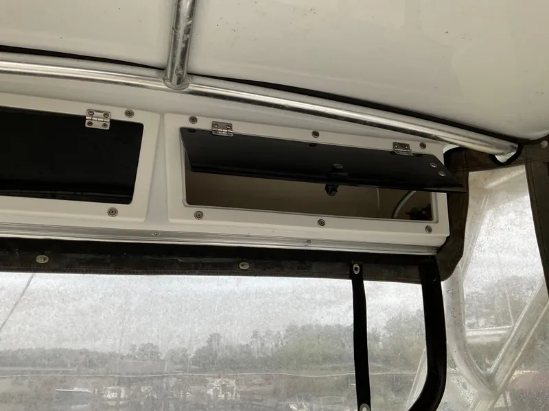 Slide: The Image of 2009 Key West 2300WA boat interior storage compartments with open hatches. - 20