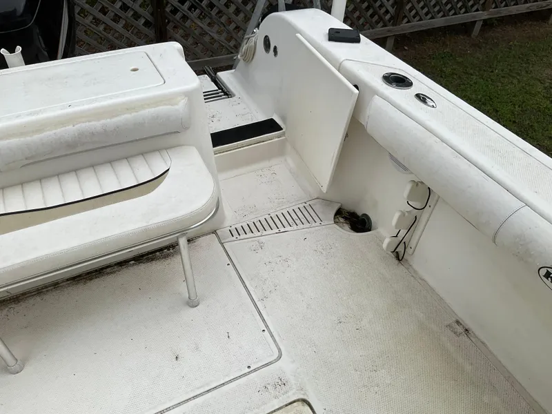 Slide: The Image of 2009 Key West 2300WA boat interior with white seating and deck. - 21