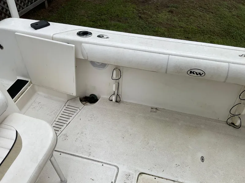 Slide: The Image of 2009 Key West 2300WA boat interior with seating and storage compartments. - 22