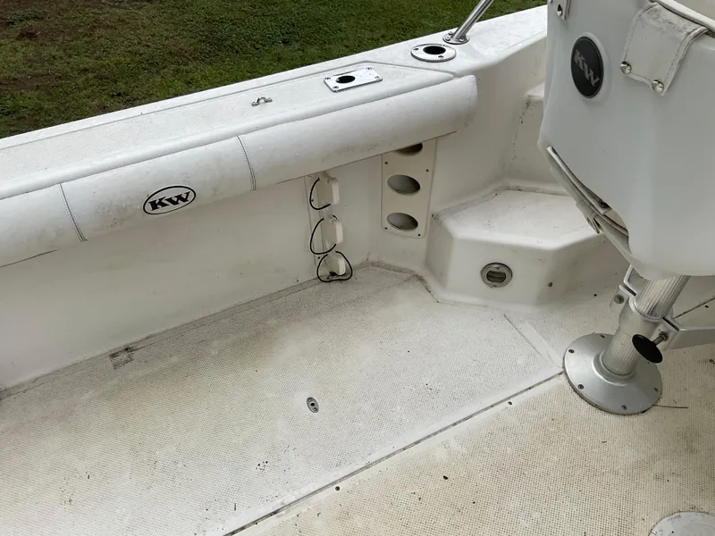Slide: The Image of 2009 Key West 2300WA boat interior with seating and storage compartments. - 23