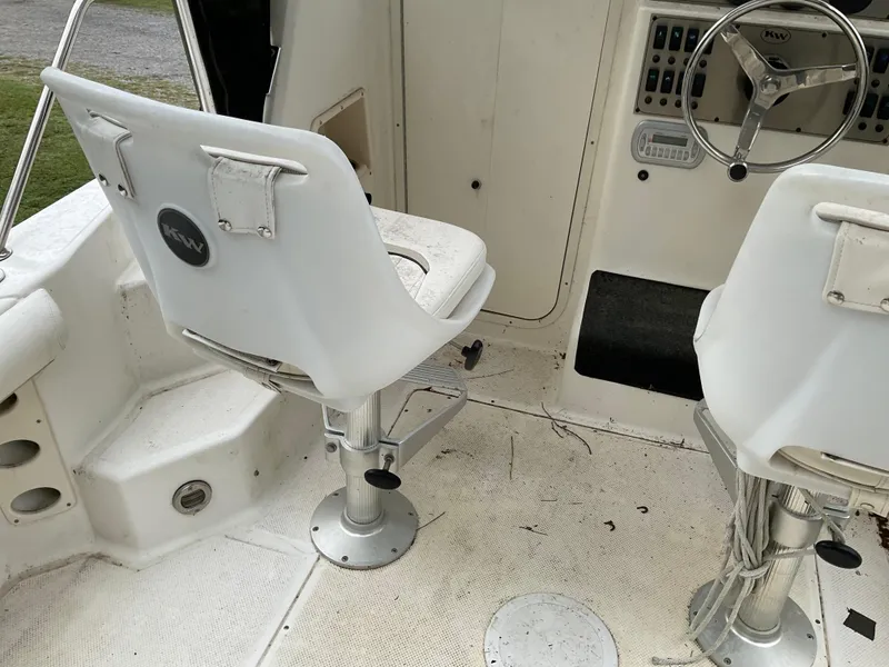 Slide: The Image of Interior of a 2009 Key West 2300WA boat showing helm seats and steering wheel. - 24