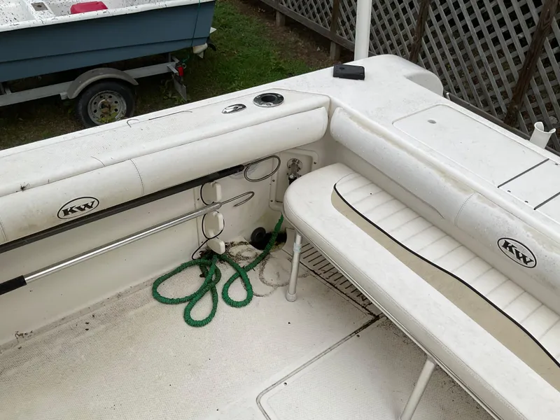 Slide: The Image of 2009 Key West 2300WA boat interior with seating and storage, featuring KW logo. - 26