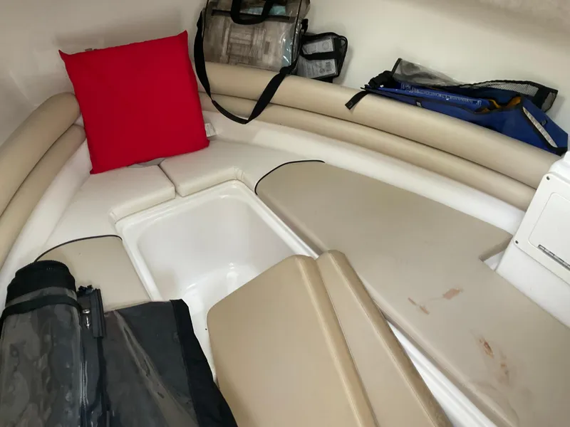 Slide: The Image of Interior of 2009 Key West 2300WA boat with seating, storage, and red cushion. - 29
