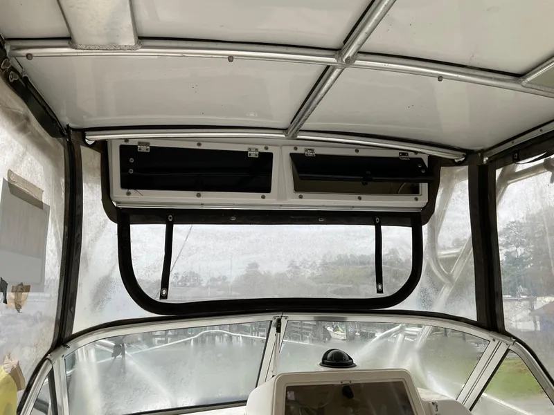 Slide: The Image of Interior view of a 2009 Key West 2300WA boat's helm with storage compartments. - 32