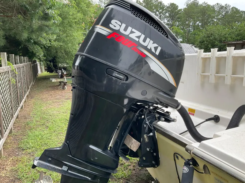 Slide: The Image of Suzuki outboard motor on 2009 Key West 2300WA boat, parked outdoors. - 36