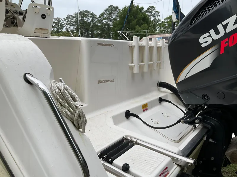 Slide: The Image of 2009 Key West 2300WA boat with Suzuki outboard motor and fishing rod holders. - 38