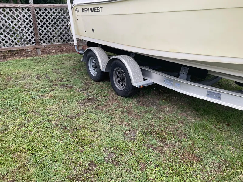 Slide: The Image of 2009 Key West 2300WA boat on trailer, parked on grass. - 4