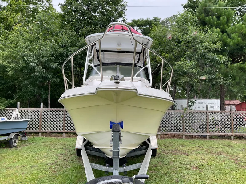 Slide: The Image of 2009 Key West 2300WA boat on trailer, surrounded by greenery. - 5