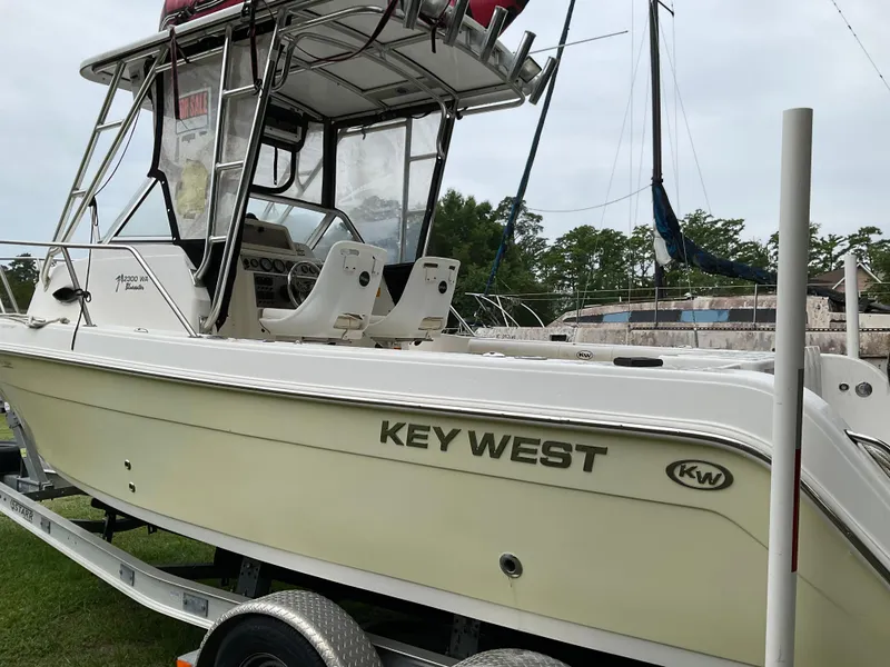Slide: The Image of 2009 Key West 2300WA boat on trailer, side view with visible cockpit and seating. - 6