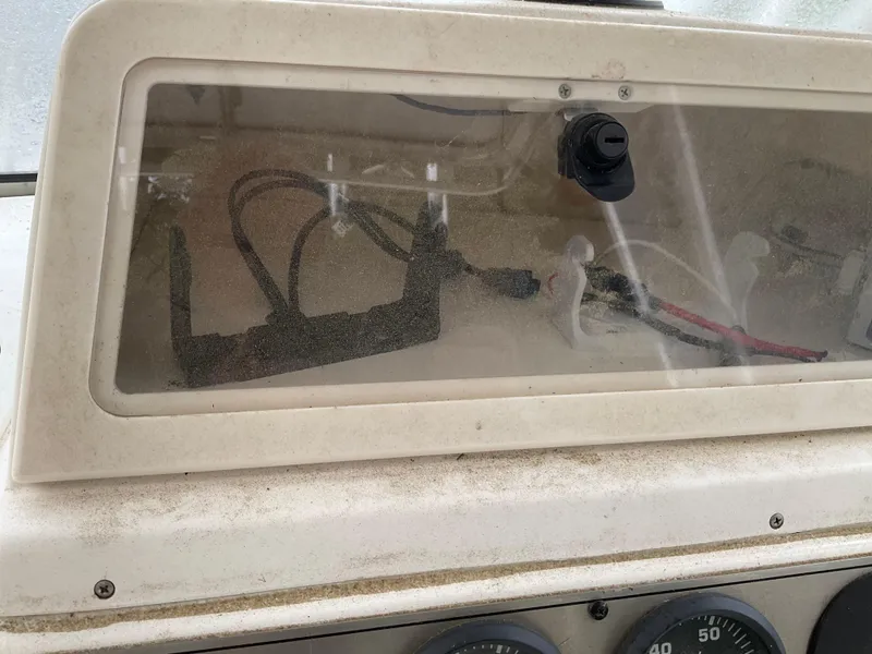 Slide: The Image of Dashboard of a 2009 Key West 2300WA boat with visible wiring and controls. - 8