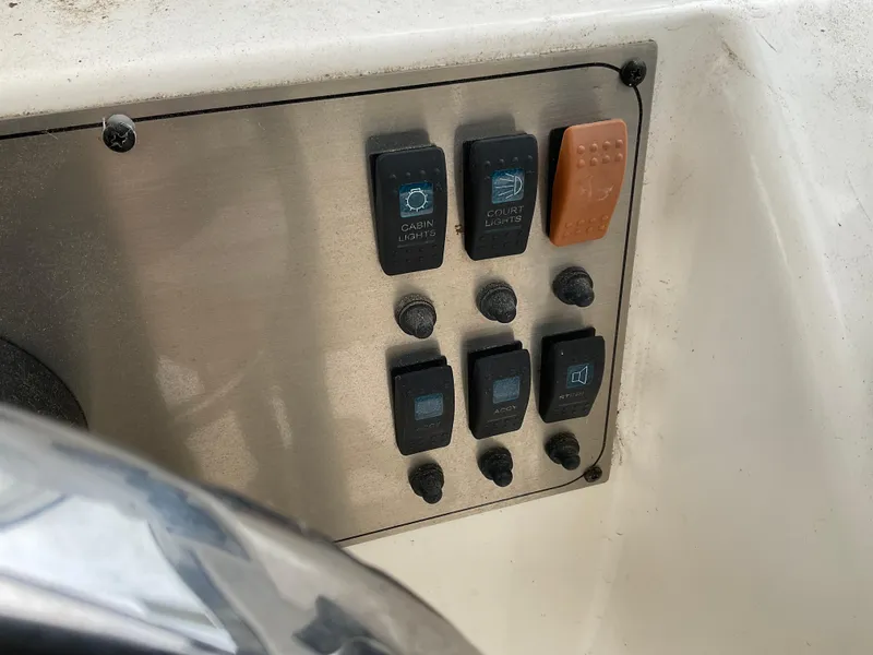 Slide: The Image of Control panel of a 2009 Key West 2300WA boat with labeled switches. - 9
