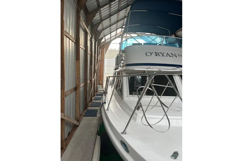 Slide: The Image of 1976 Uniflite 32 Sport Sedan docked in a covered marina. - 11