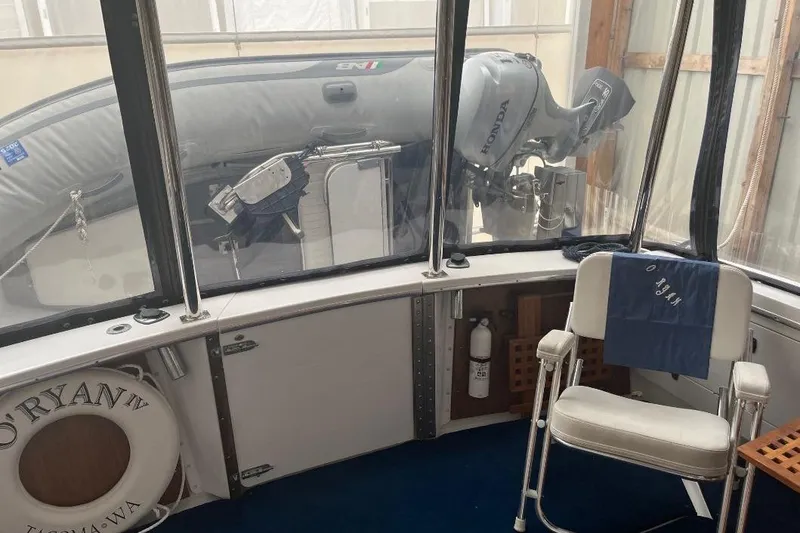 Slide: The Image of 1976 Uniflite 32 Sport Sedan interior with life preserver and Honda outboard motor. - 15