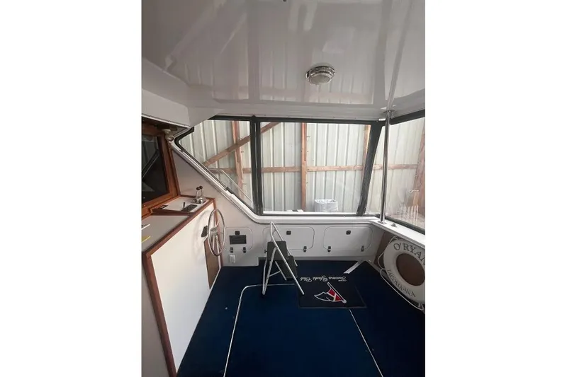 Slide: The Image of 1976 Uniflite 32 Sport Sedan interior with steering wheel and windows. - 16