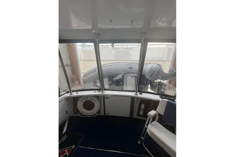 Slide: The Image of 1976 Uniflite 32 Sport Sedan interior with view of inflatable boat outside. - 17