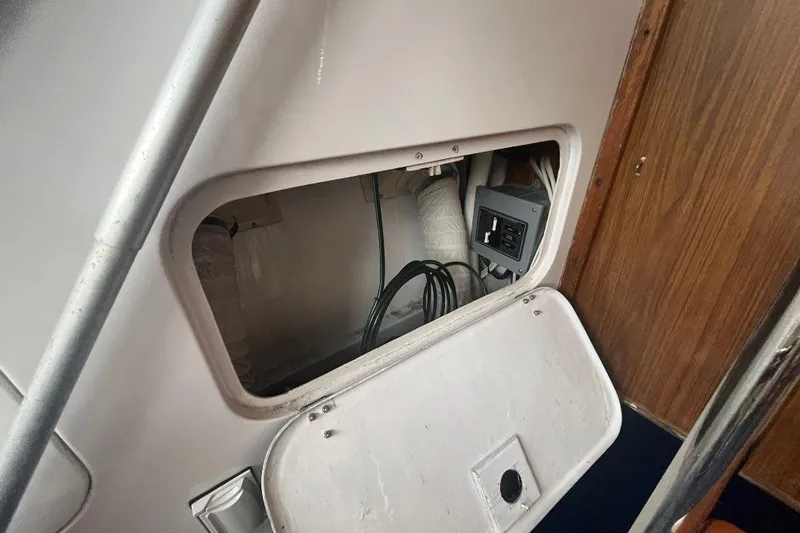 Slide: The Image of 1976 Uniflite 32 Sport Sedan interior compartment with wiring and electrical panel. - 22