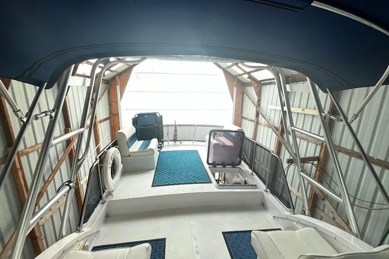 Slide: The Image of 1976 Uniflite 32 Sport Sedan interior with blue canopy and seating area. - 29