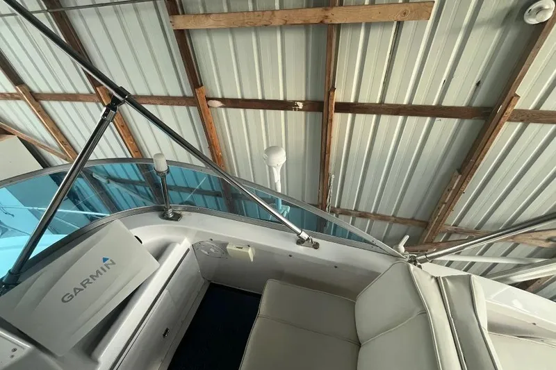 Slide: The Image of 1976 Uniflite 32 Sport Sedan interior with Garmin equipment, under metal roof. - 30