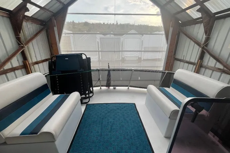 Slide: The Image of 1976 Uniflite 32 Sport Sedan interior with blue-striped seating and a blue rug. - 36