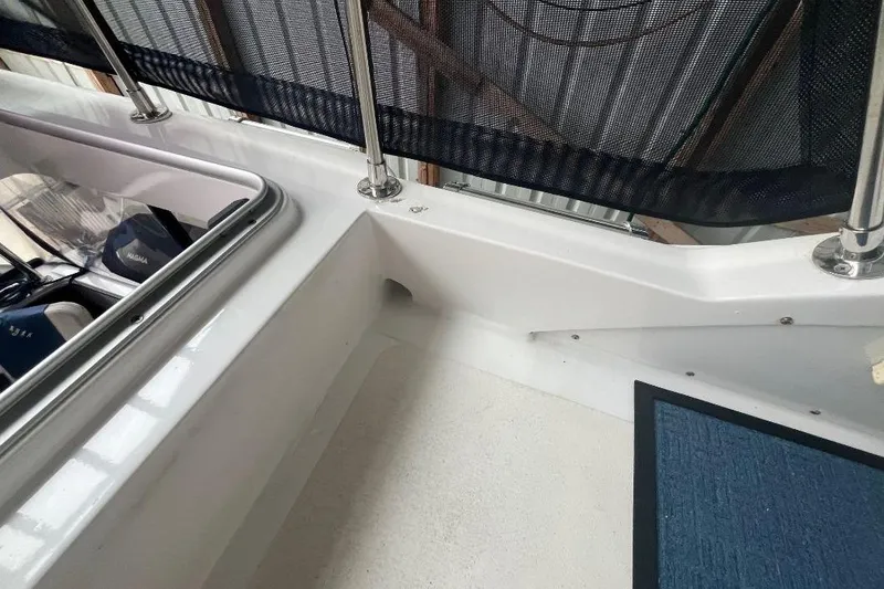 Slide: The Image of 1976 Uniflite 32 Sport Sedan boat deck with railing and storage compartment. - 37